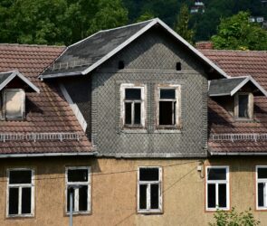 a house with a clock on the front of it