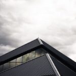 gray and black building under white clouds