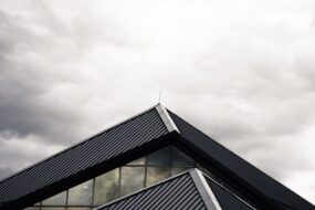 gray and black building under white clouds