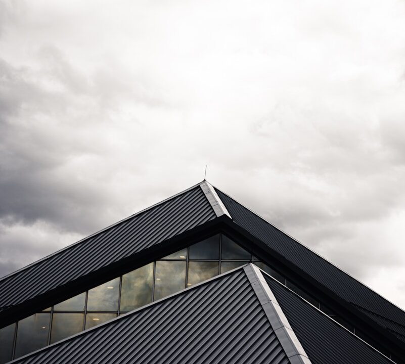 gray and black building under white clouds